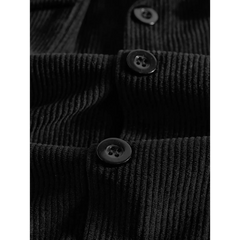 Black corduroy jacket close-up of button placket and ribbed fabric