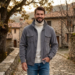 Gray corduroy jacket worn in an old stone village in autumn