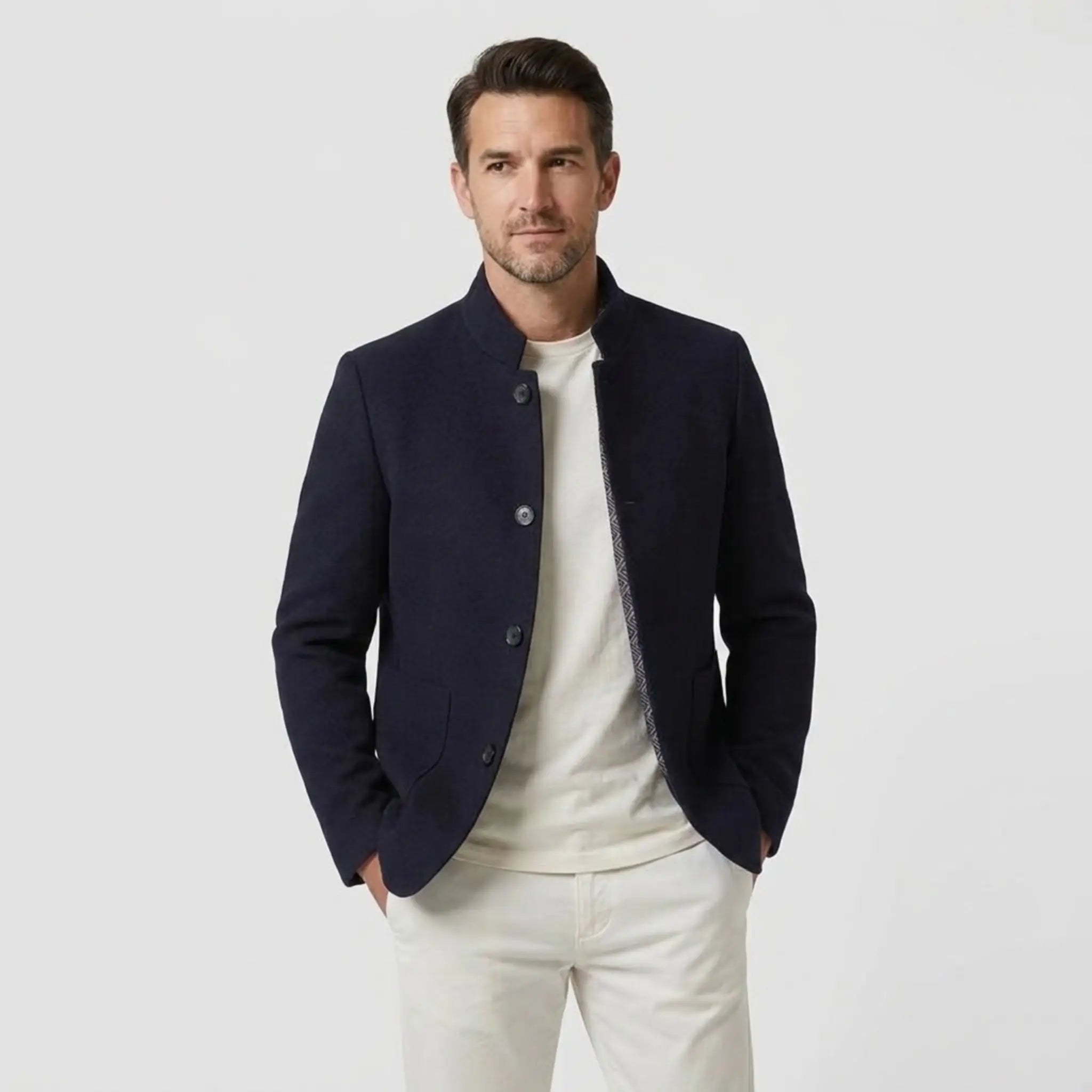 MannerCo navy blue double-faced wool overcoat with stand collar worn open over white tee