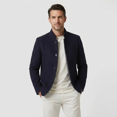 MannerCo navy blue double-faced wool overcoat with stand collar worn open over white tee