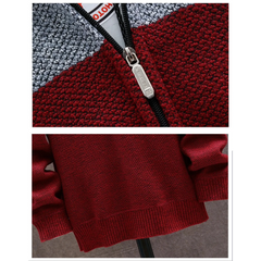 Close-up of the metal zip and ribbed hem on the wine red knit hoodie