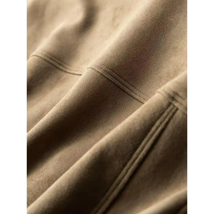 Close-up of the seam stitching and suede-like texture on a khaki trucker jacket