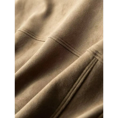 Close-up of the stitched panel seams on a khaki suede-look trucker jacket