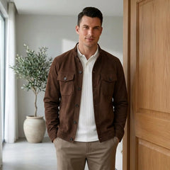 Man in deep brown suede jacket and white tee in a bright modern interior