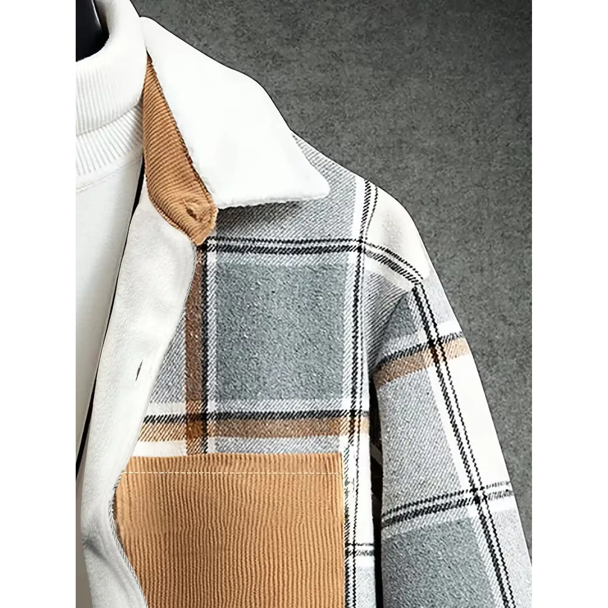 Corduroy collar and chest pocket detail on light grey plaid shirt jacket