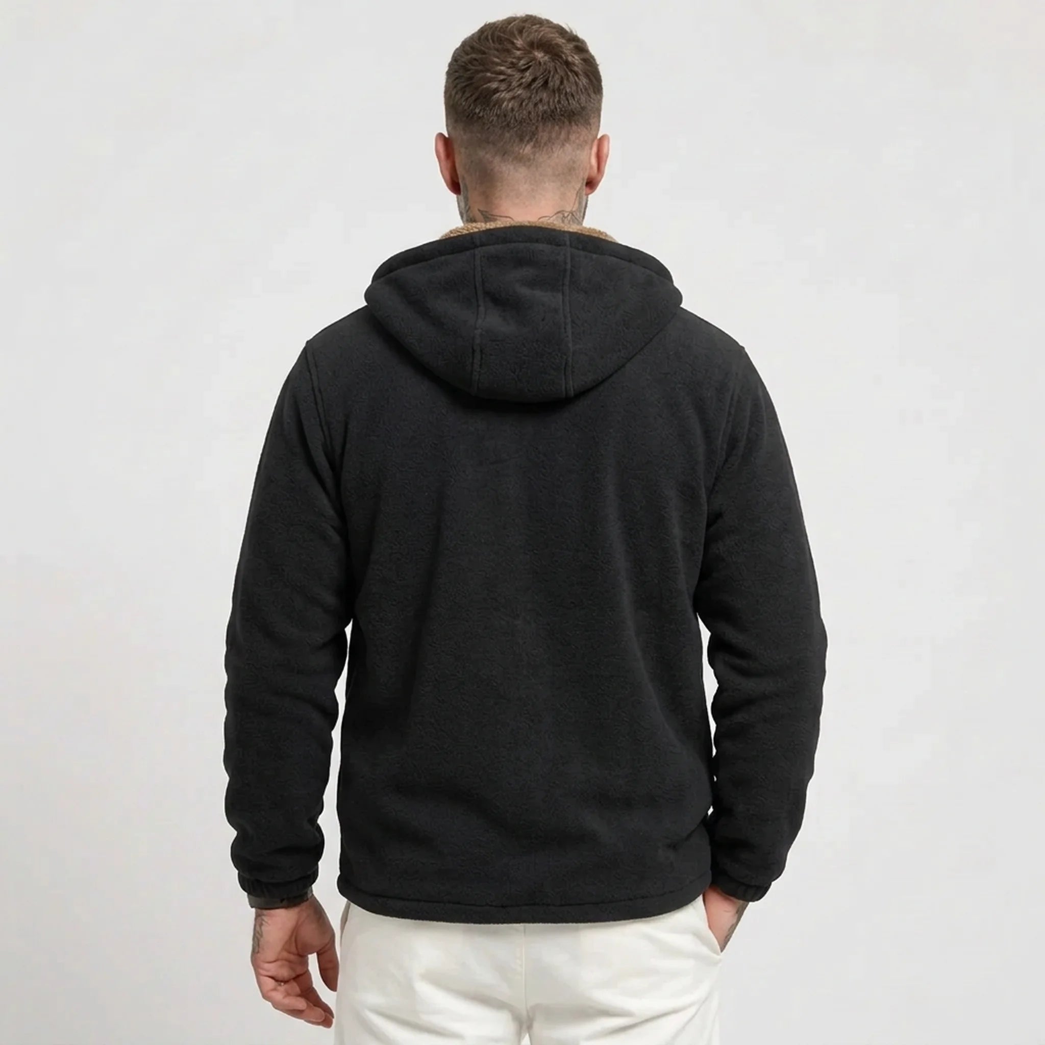 Black sherpa-lined fleece jacket on model, back view
