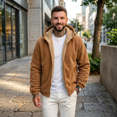 Man wearing caramel sherpa fleece hooded jacket with white tee on a city street