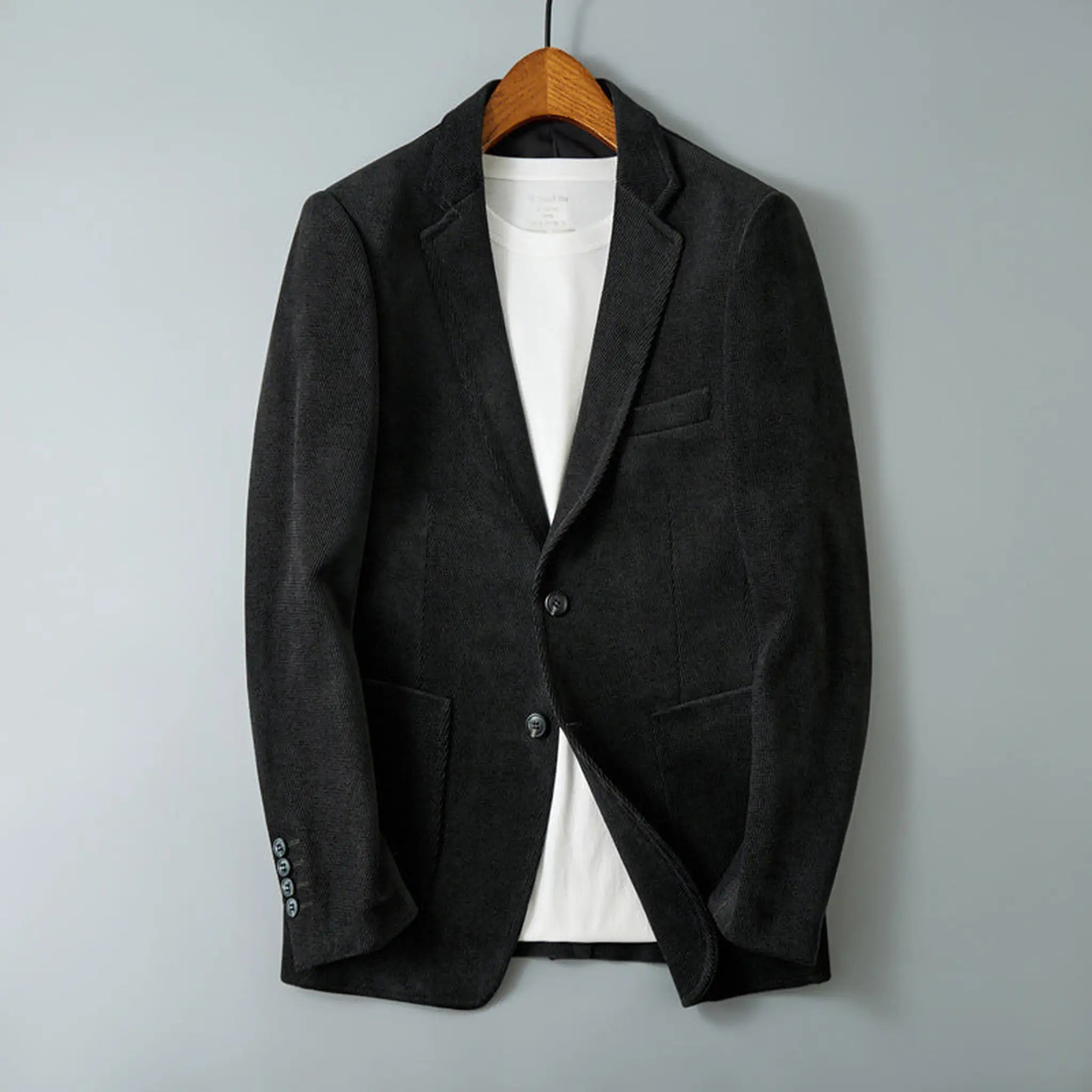 Black blazer on a hanger, front view with notch lapel