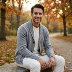 MannerCo men's light gray lapel cardigan sweater worn outdoors in autumn park setting
