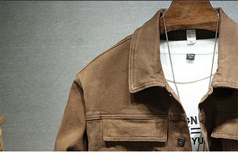 Brown denim jacket collar and chest pocket close-up