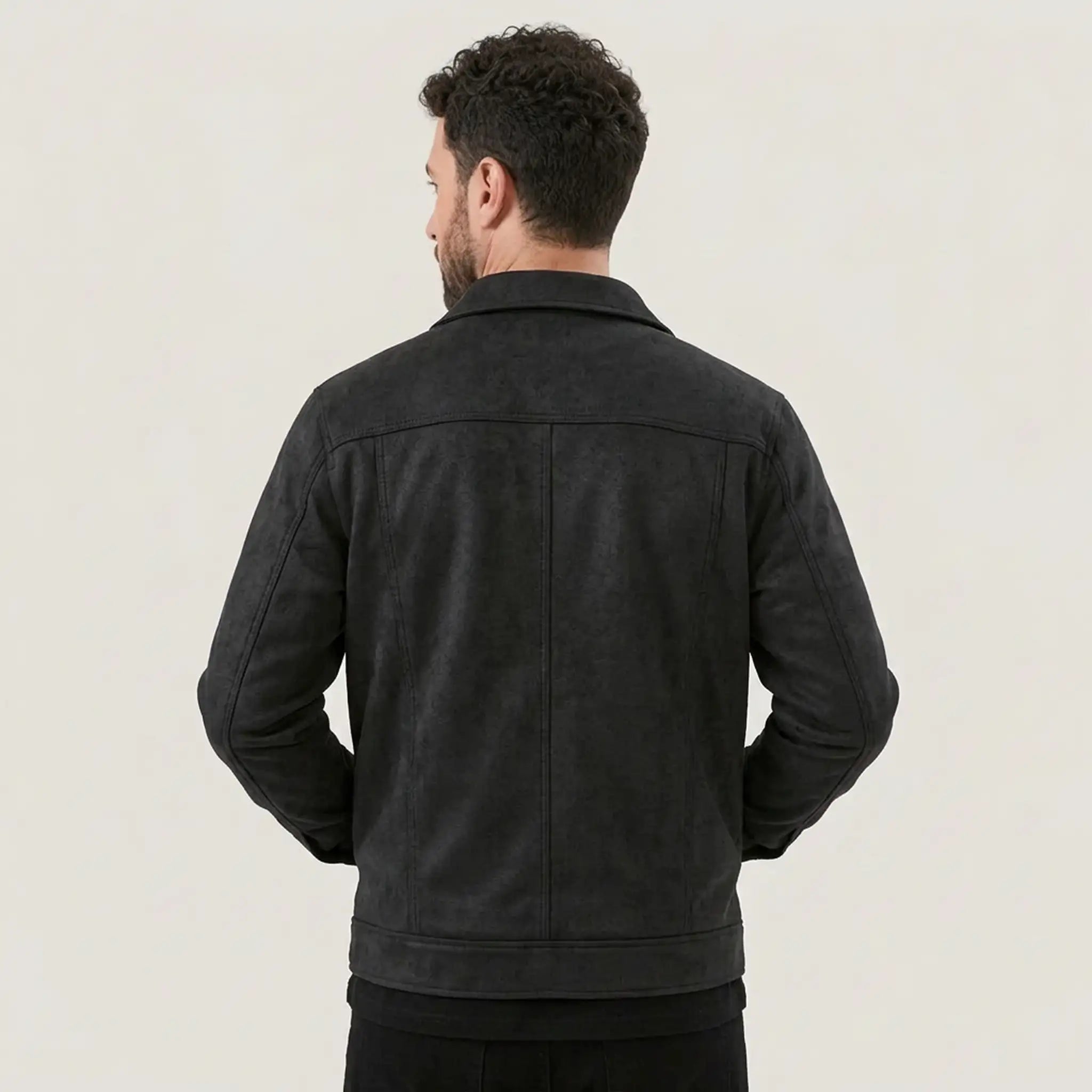 Back view of a man wearing a black suede-look trucker jacket