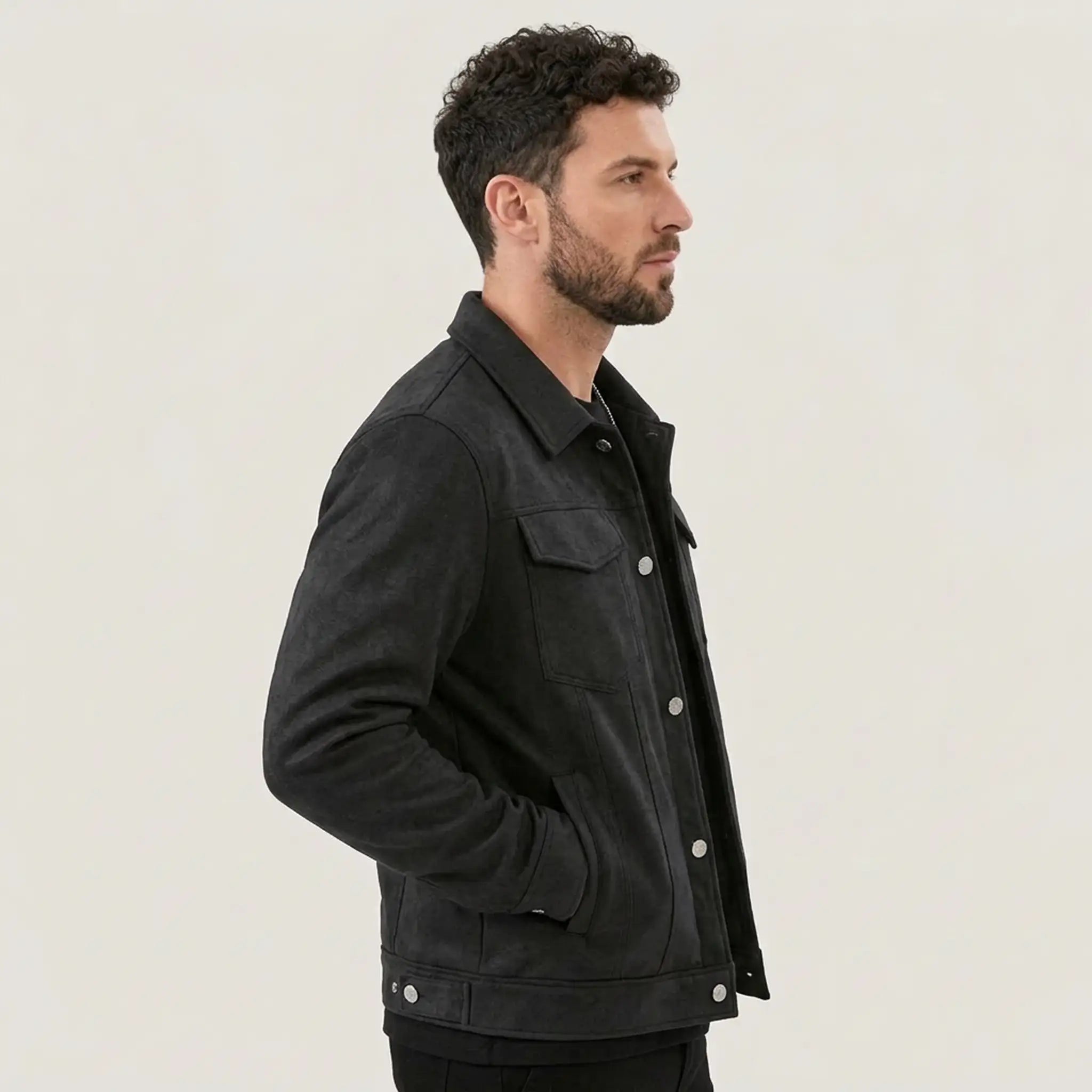 Man in a black suede-look trucker jacket, side profile view