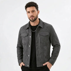 Man wearing a gray suede-look trucker jacket over a black tee, front view