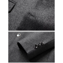 Grey wool blend blazer close-up of chest welt pocket and sleeve buttons
