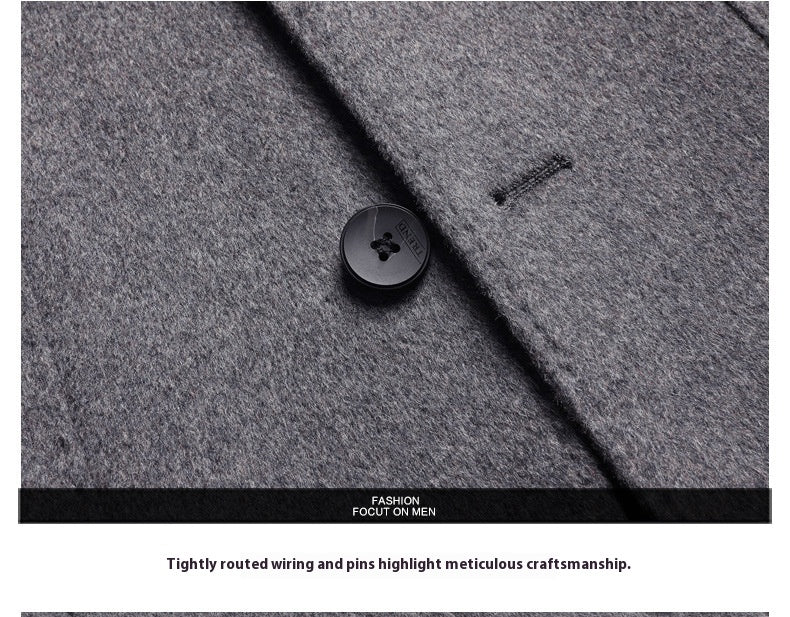 MannerCo men's wool overcoat black button and precise stitching on light gray fabric detail
