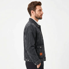 Washed black workwear denim jacket on model, side view