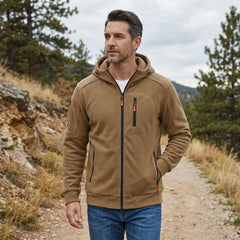 MannerCo khaki fleece hoodie worn on a forest hiking trail