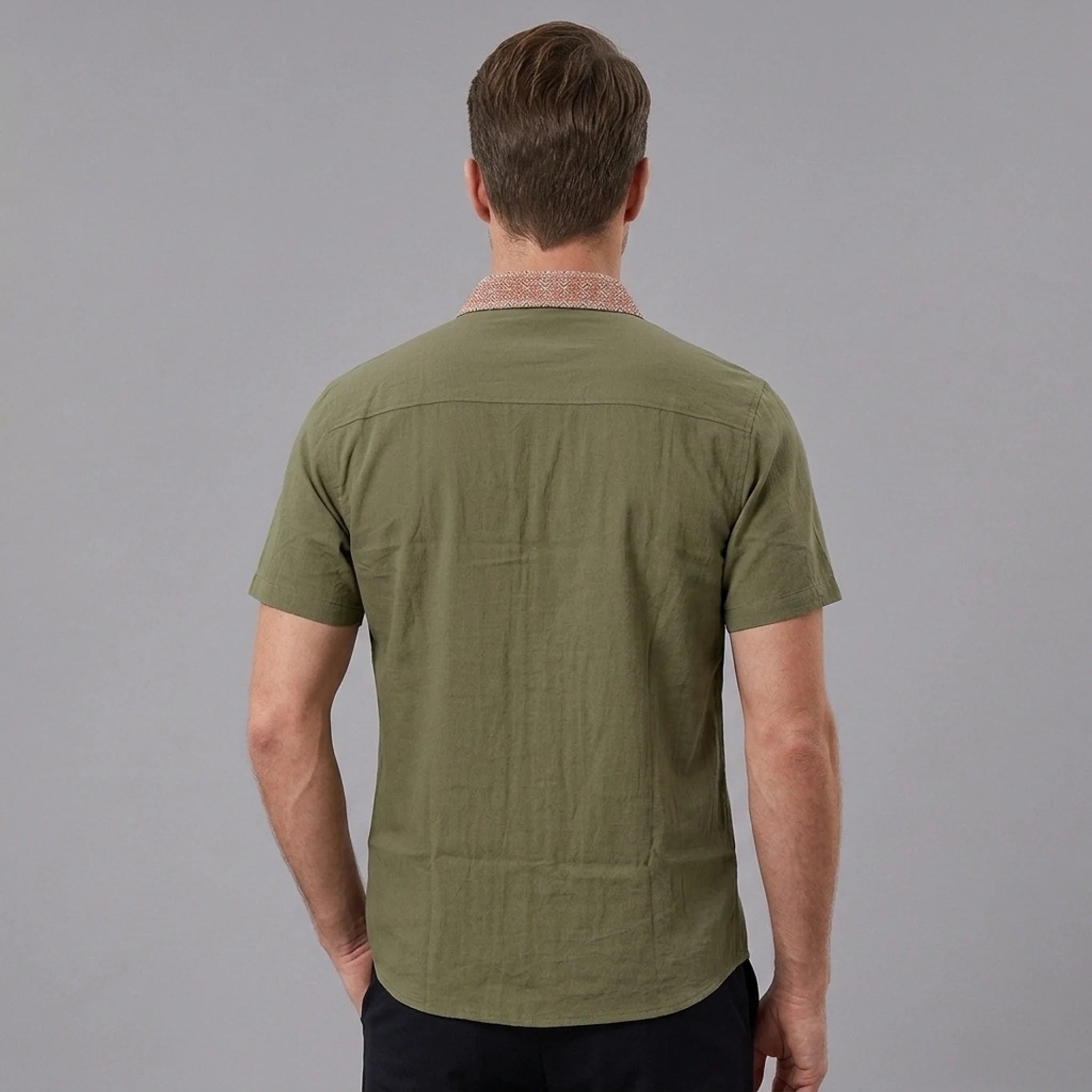 MannerCo military green linen blend short sleeve shirt with contrast collar, back view on male model