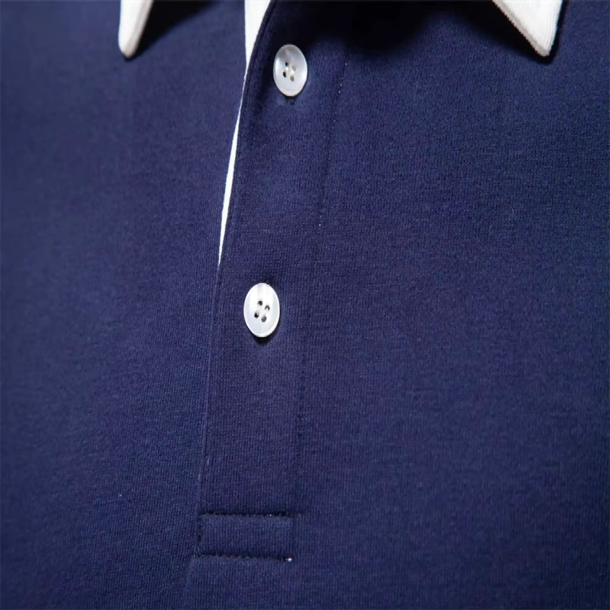MannerCo navy blue polo collar hoodie detail showing white contrast collar and pearl buttons