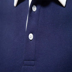 MannerCo navy blue polo collar hoodie detail showing white contrast collar and pearl buttons