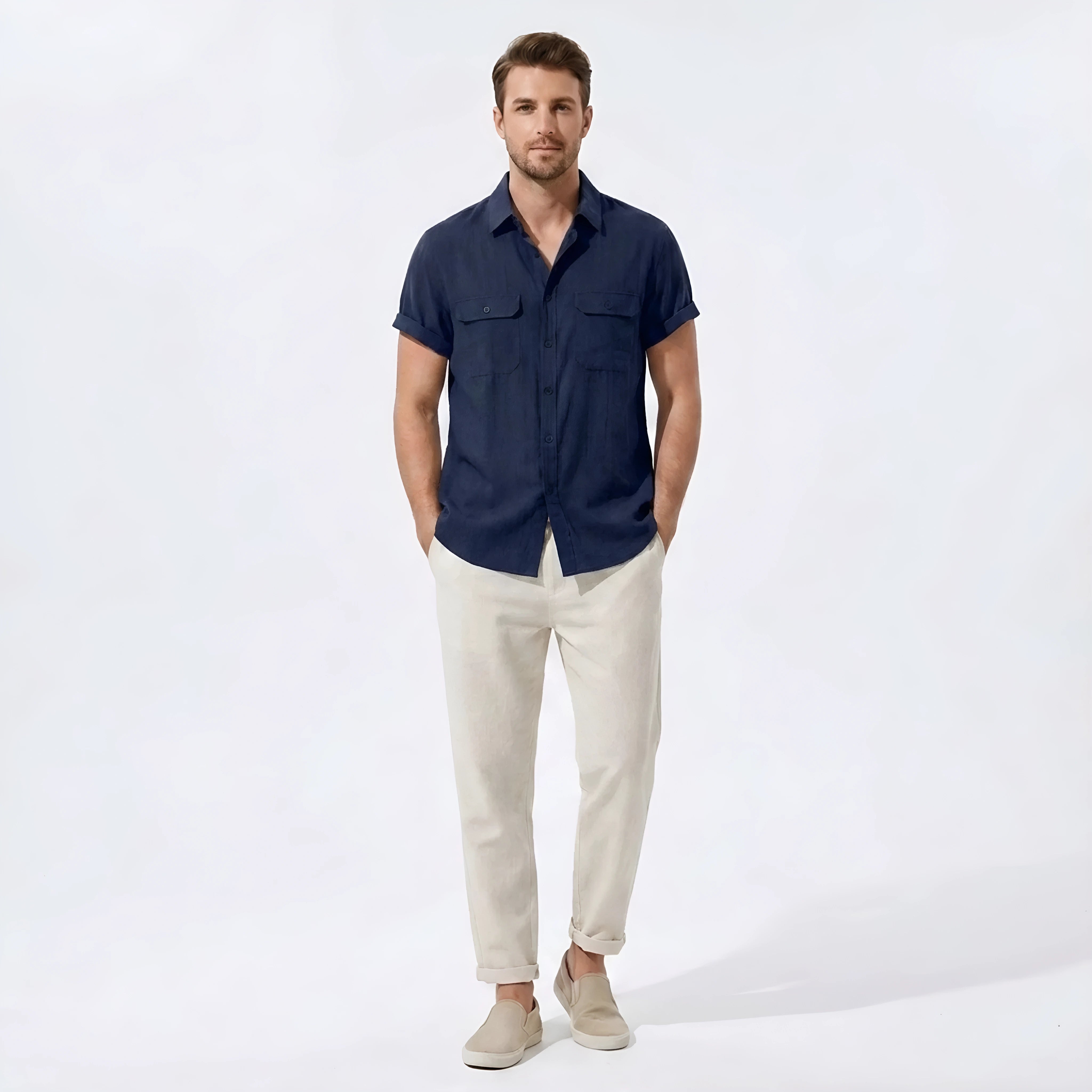 Man wearing a navy linen rayon blend pocket utility shirt and straight leg linen pants front view on plain background