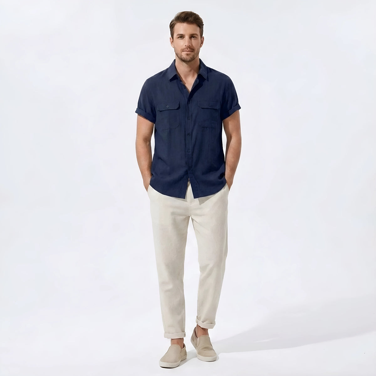Man wearing a navy linen rayon blend pocket utility shirt and straight leg linen pants front view on plain background