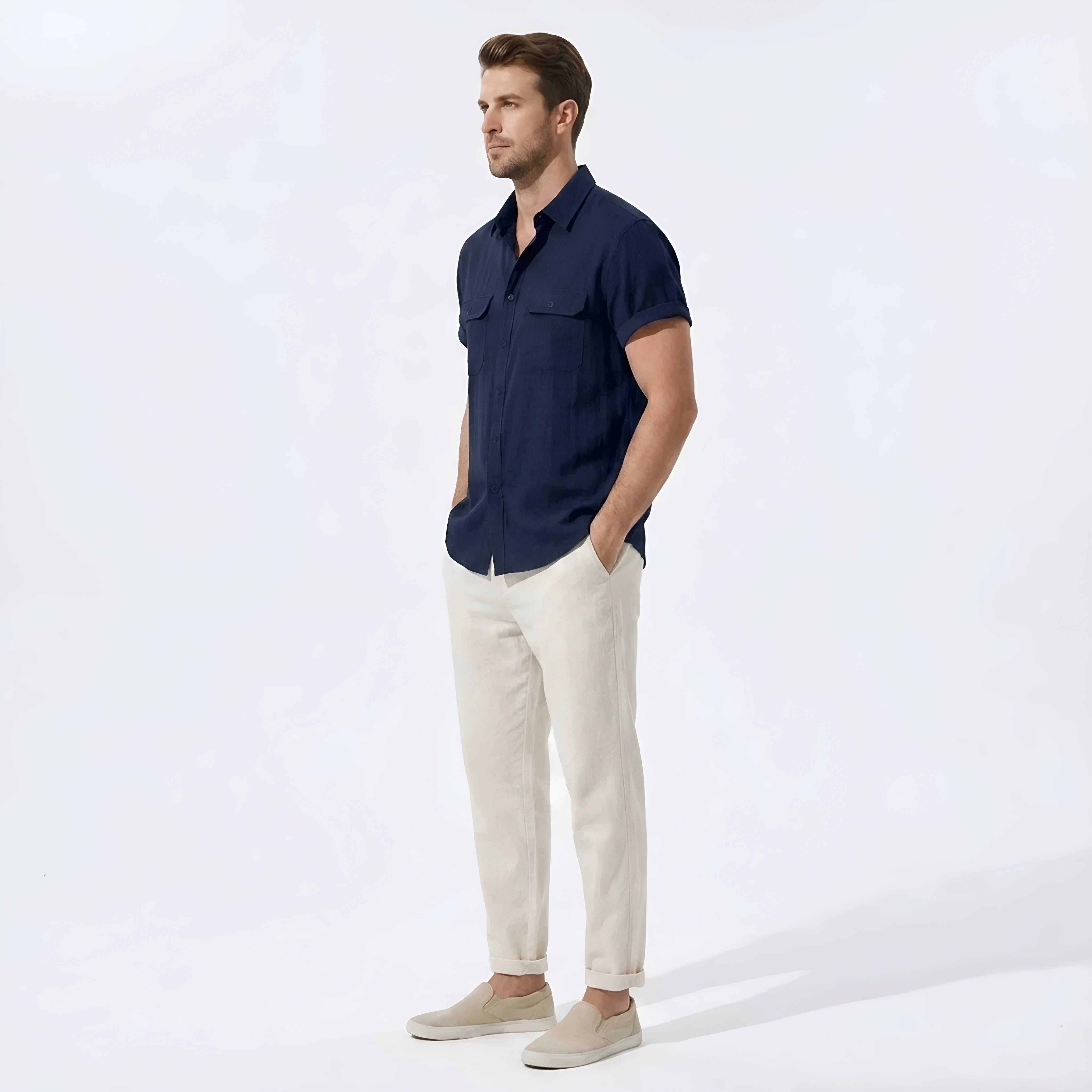 Side view of man in navy linen rayon blend pocket utility shirt and straight leg linen pants