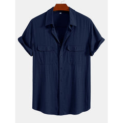 Navy blue short-sleeve shirt on a hanger with a white background