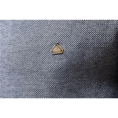 MannerCo navy cardigan sweater gold triangle logo detail on textured fabric