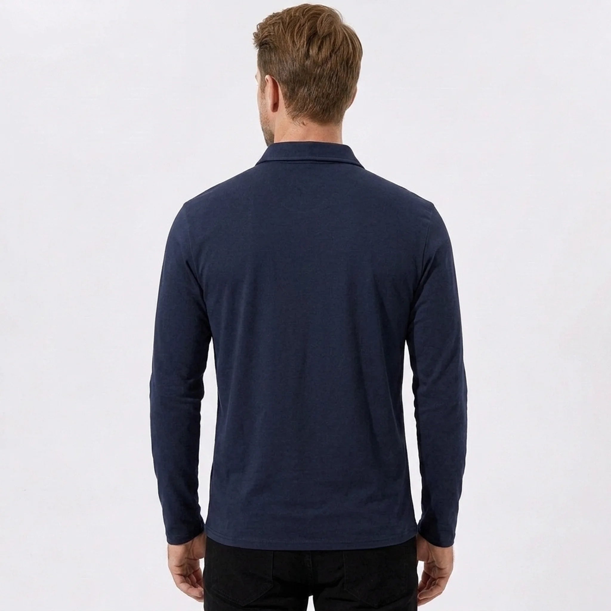 Back view of man wearing navy solid long sleeve cotton polo shirt