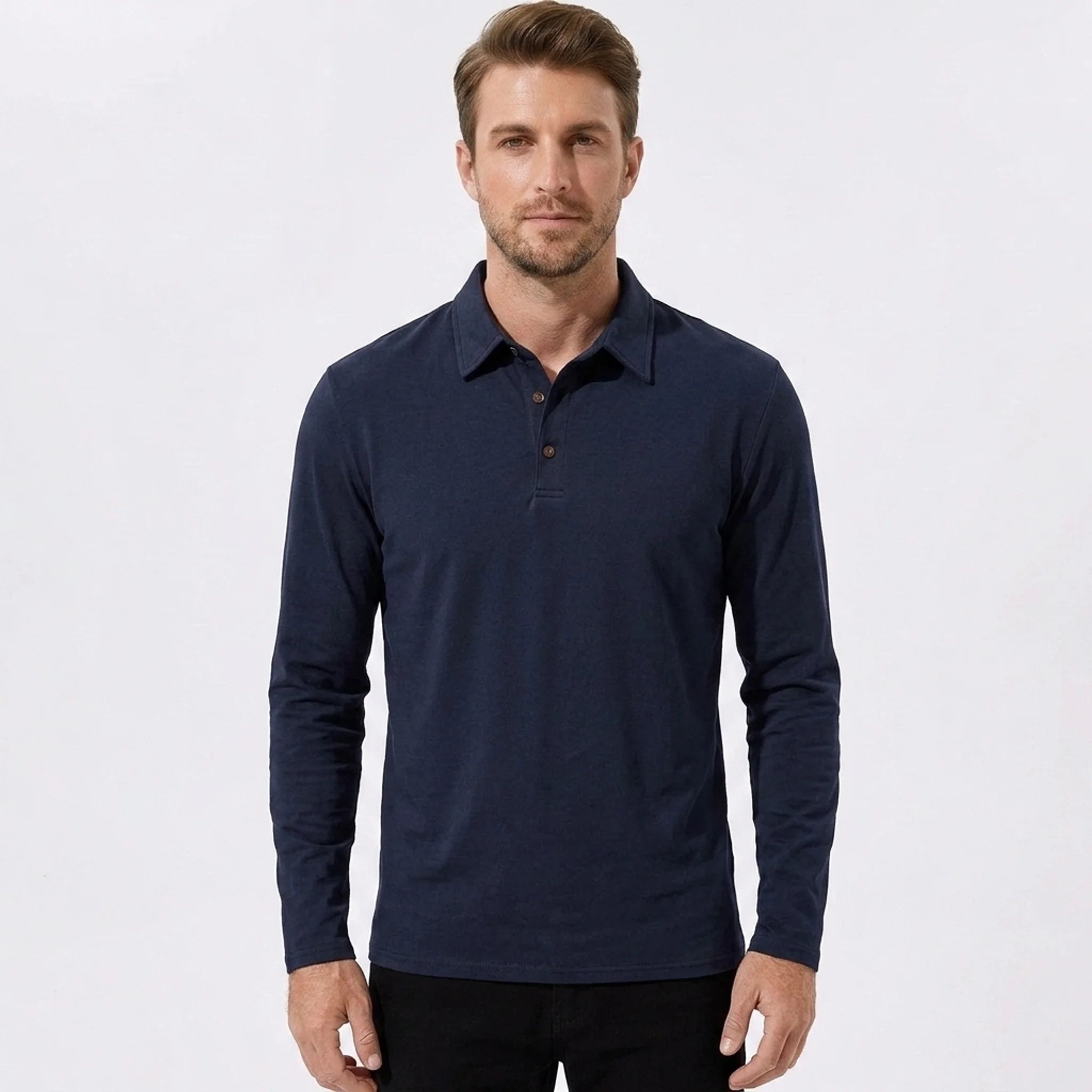 Man wearing a navy solid long sleeve cotton polo shirt front view on plain background