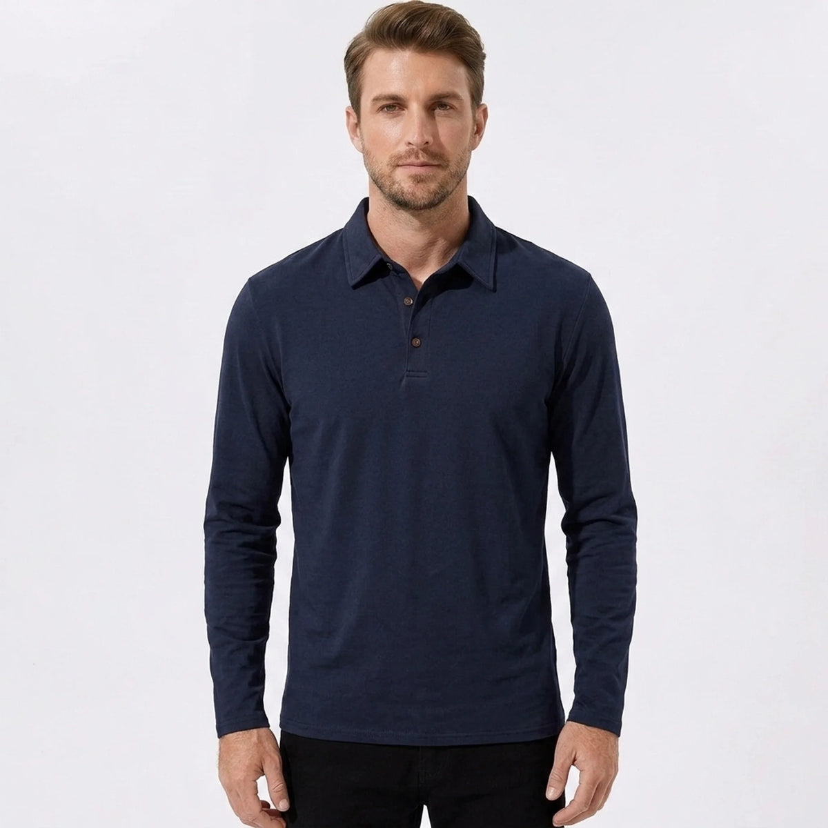 Man wearing a navy solid long sleeve cotton polo shirt front view on plain background