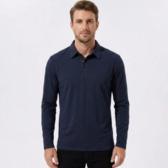 Man wearing a navy solid long sleeve cotton polo shirt front view on plain background