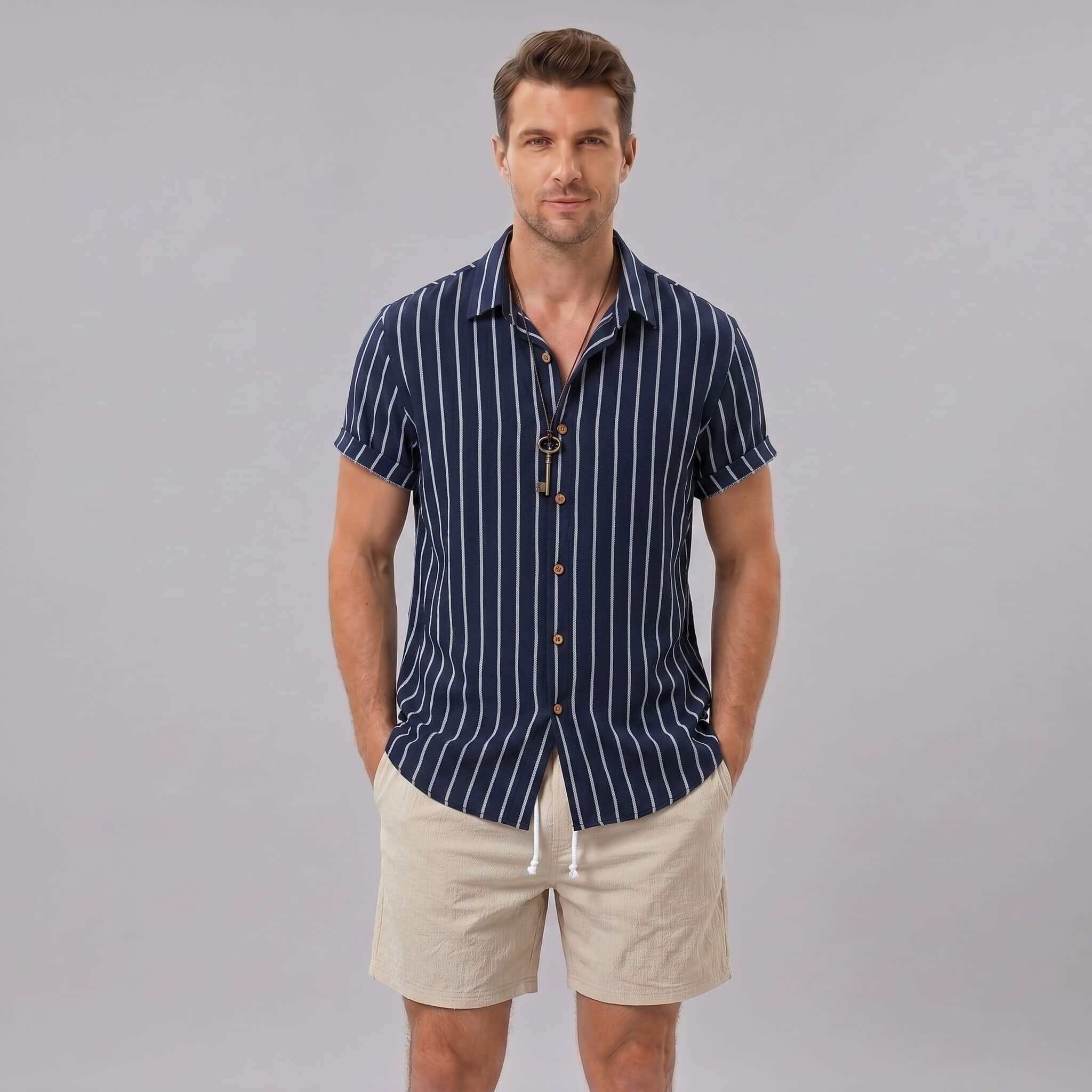 Man wearing a navy striped cotton blend button up shirt and crinkle textured drawstring shorts front view