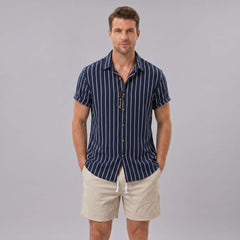 Man wearing a navy striped cotton blend button up shirt and crinkle textured drawstring shorts front view