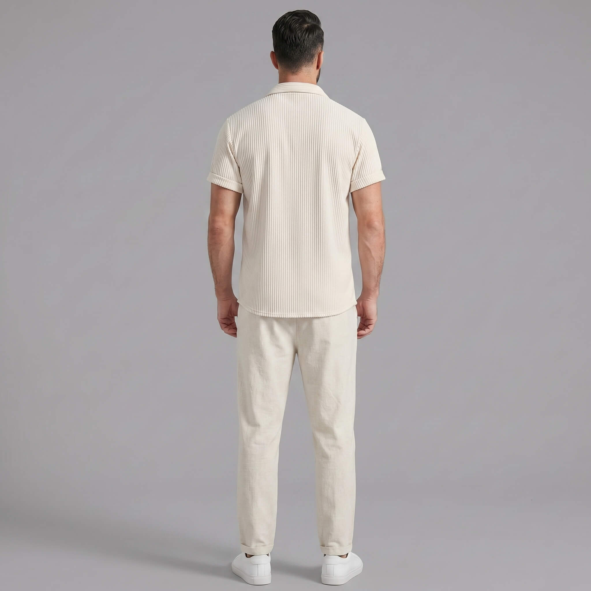 Full length view of man in navy waffle button up shirt and straight leg linen pants