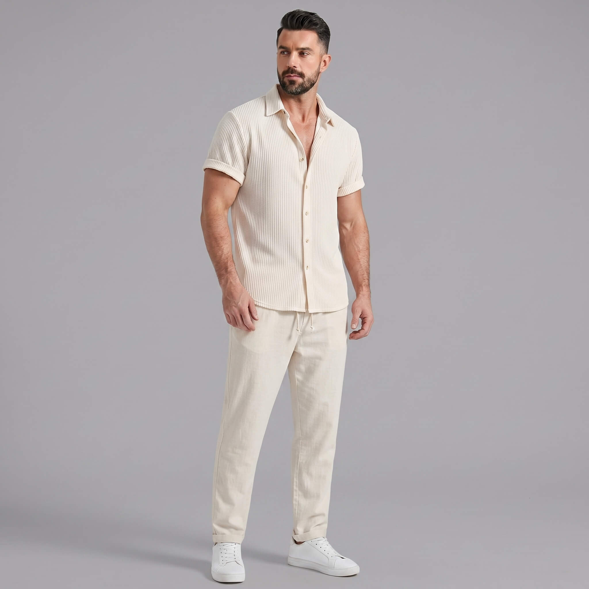Man wearing navy waffle button up shirt and linen pants in lifestyle outdoor setting