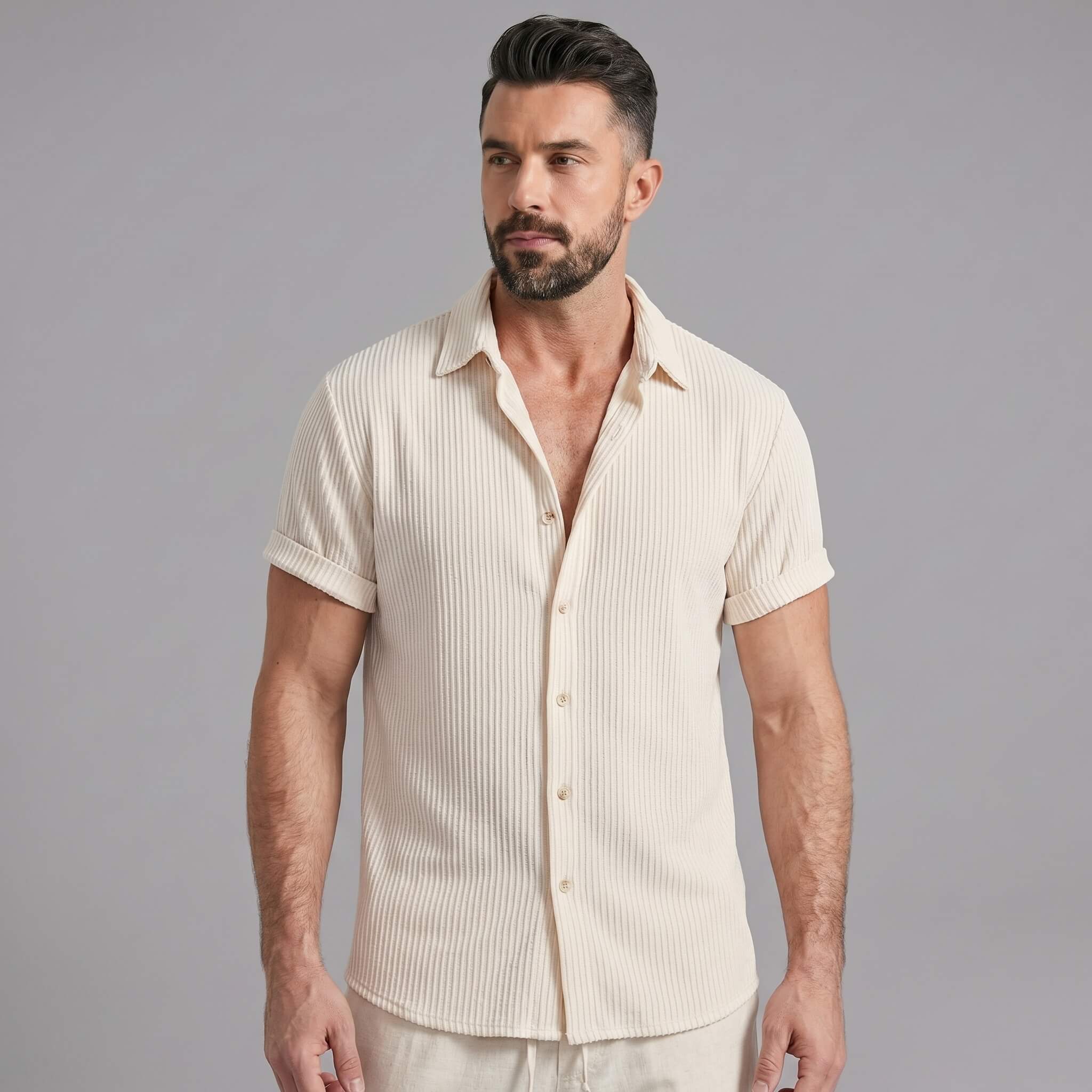 Man wearing navy waffle button up shirt and linen pants walking outdoors
