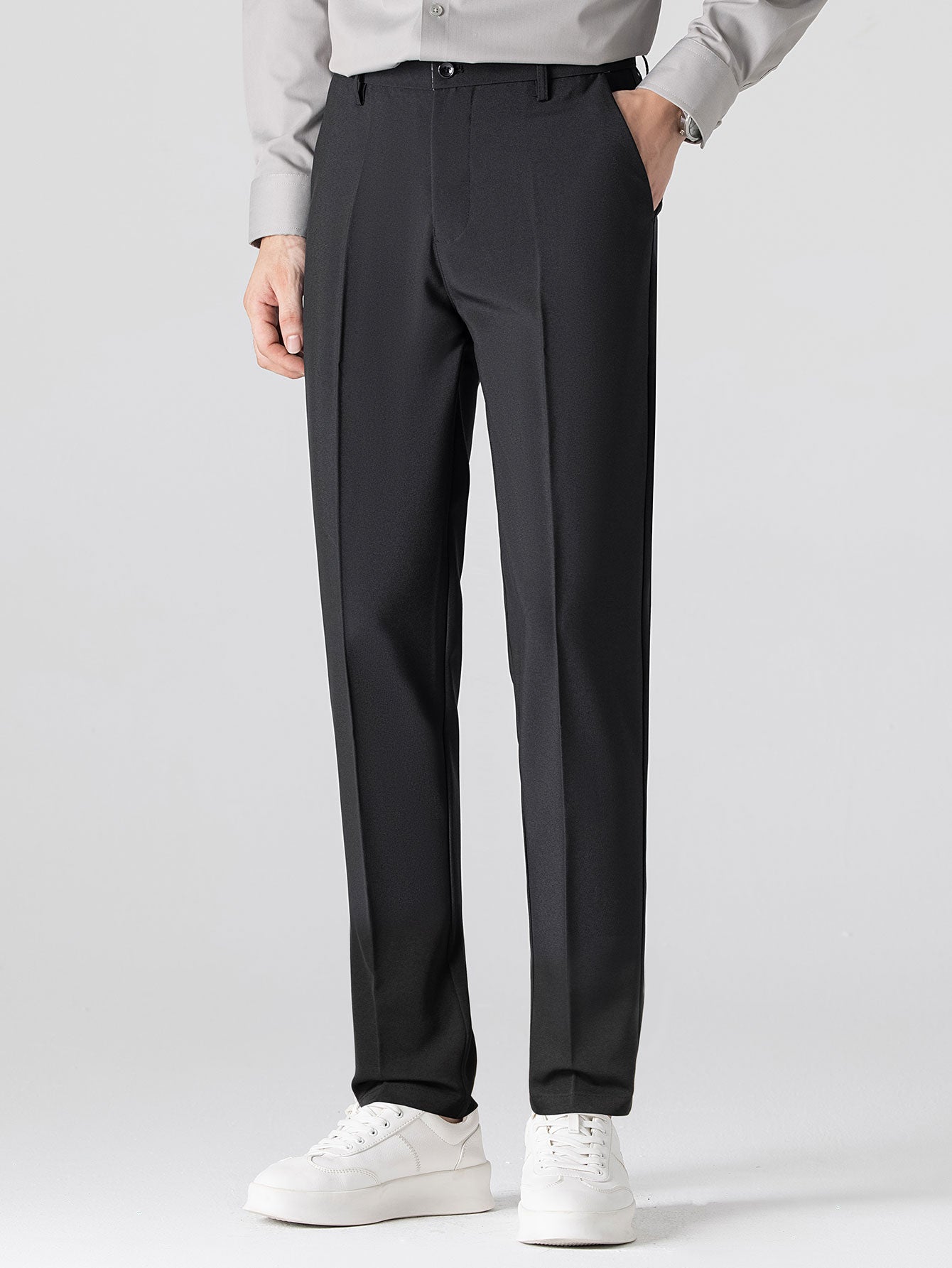 Man wearing navy waffle johnny collar polo and tapered pants in outdoor setting