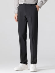 Man wearing navy waffle johnny collar polo and tapered pants in outdoor setting