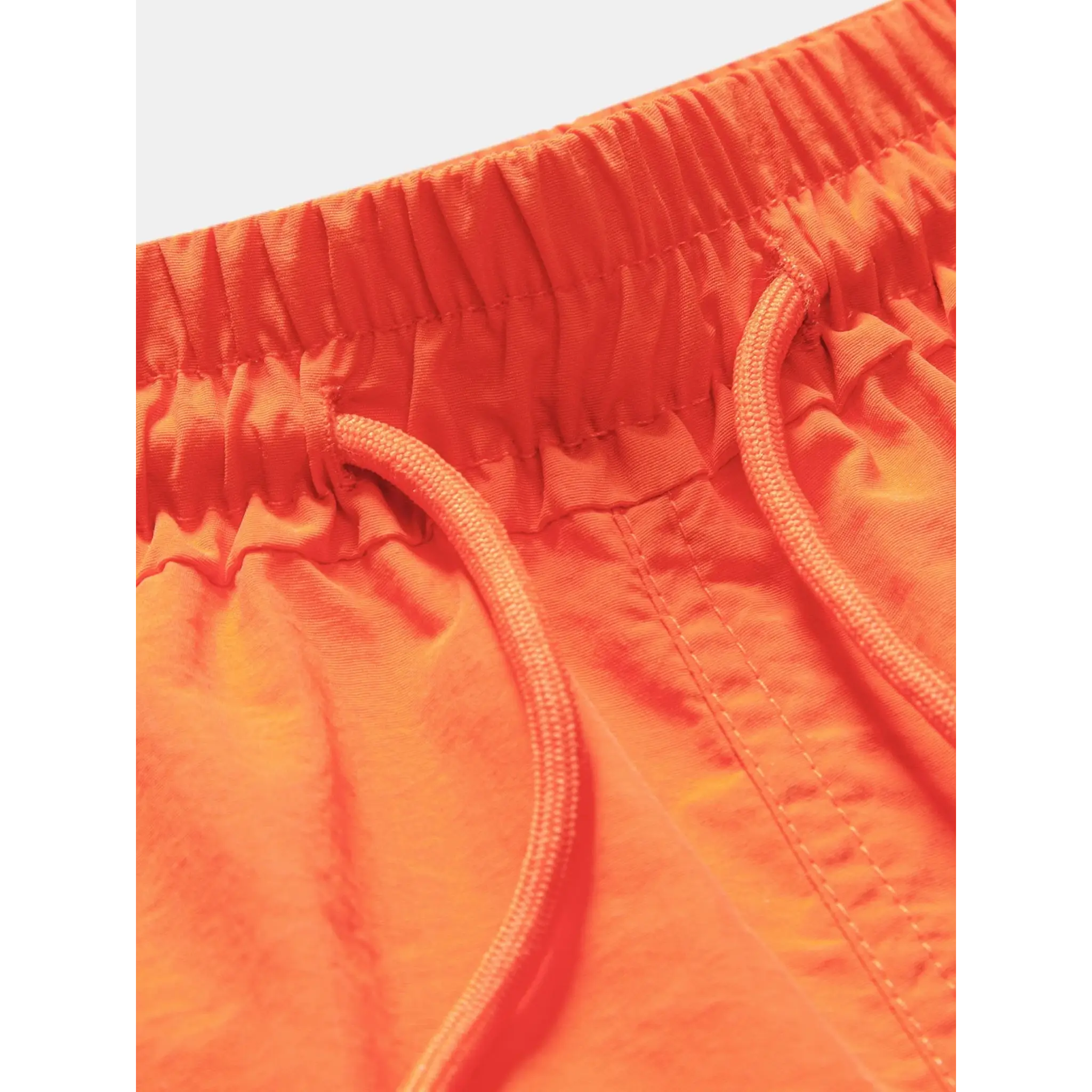Back view of man wearing orange palm tree tropical print shirt and swim shorts