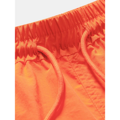 Back view of man wearing orange palm tree tropical print shirt and swim shorts