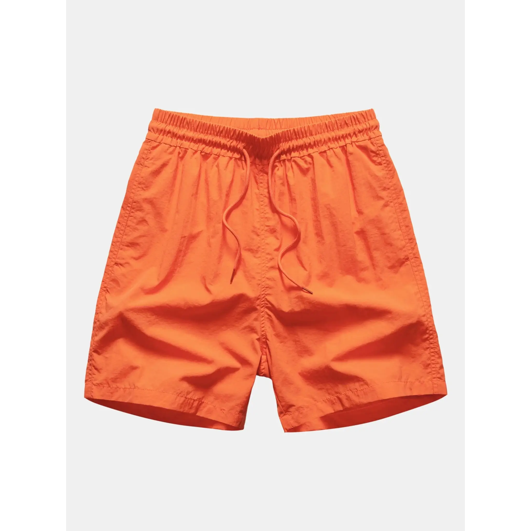 Man wearing orange palm tree tropical print button up shirt and swim shorts front view on plain background