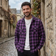MannerCo purple black plaid flannel shirt worn open over white tee on cobblestone street