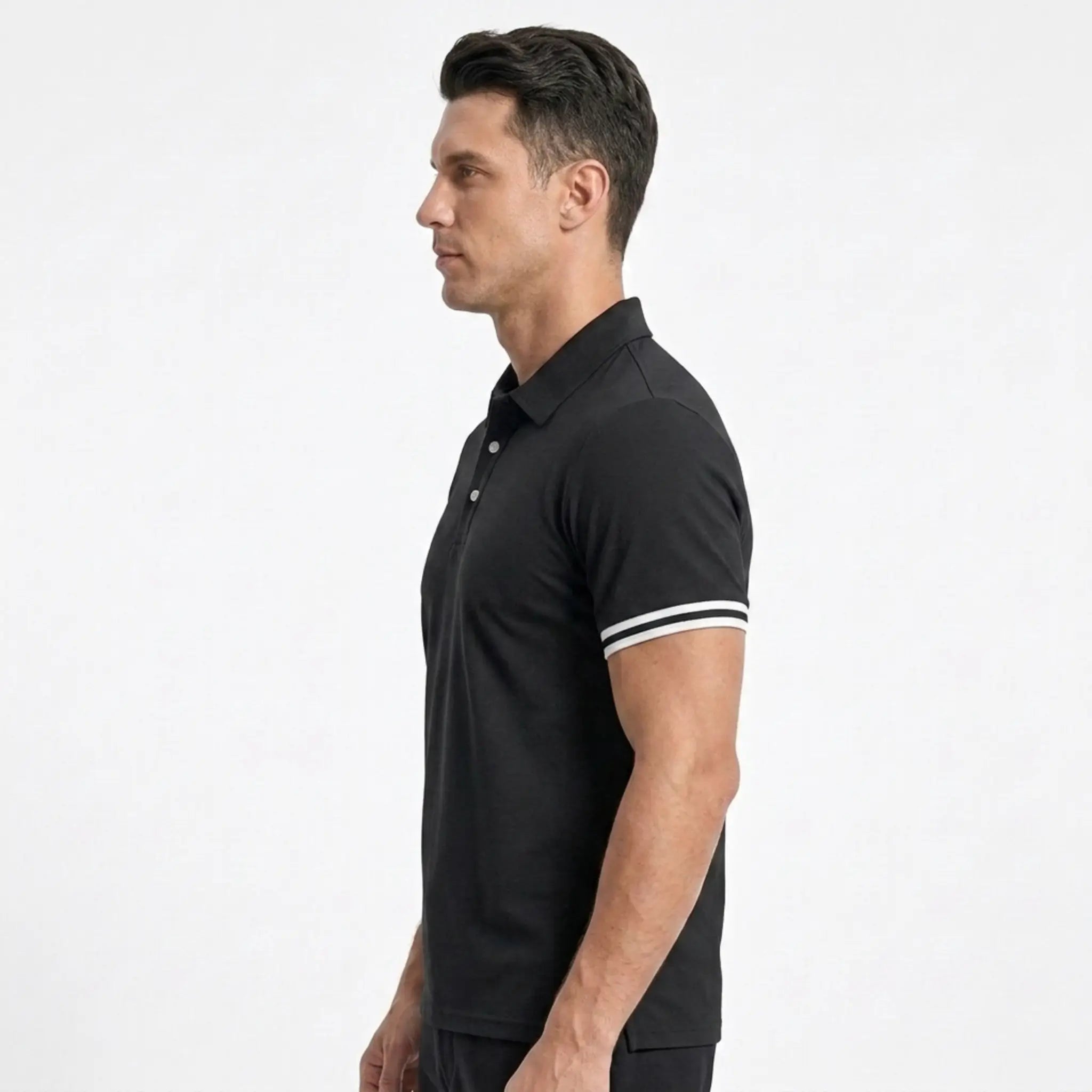 Man wearing MannerCo black polo shirt with white stripe sleeve detail, side view