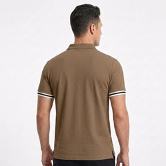 MannerCo brown polo shirt back view with white and black striped cuffs on male model