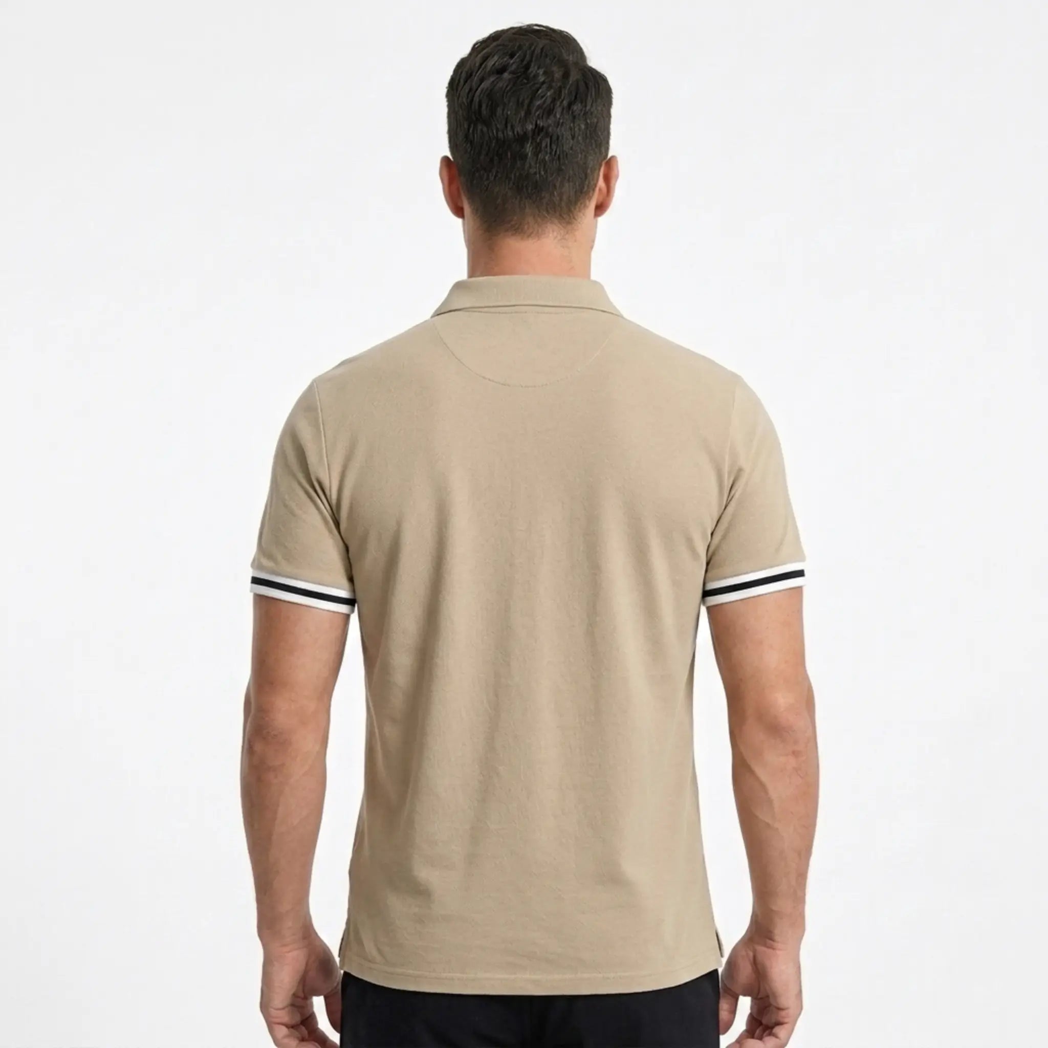 MannerCo khaki polo shirt back view with black and white sleeve tipping on male model