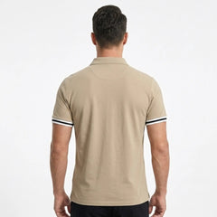 MannerCo khaki polo shirt back view with black and white sleeve tipping on male model