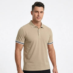 MannerCo khaki polo shirt with black and white striped sleeve cuffs, worn by male model, front view