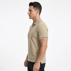 MannerCo khaki polo shirt side view with striped cuffs on male model